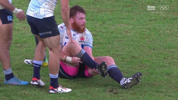 Harry Johnson-Holmes clutches his leg after falling in the Waratahs vs Brumbies match.