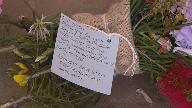 A shrine of flowers is growing outside of the police station in Lucindale.