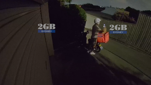 An Uber Eats driver has been caught taking a customer's food order on CCTV footage obtained by 2GB Radio. 