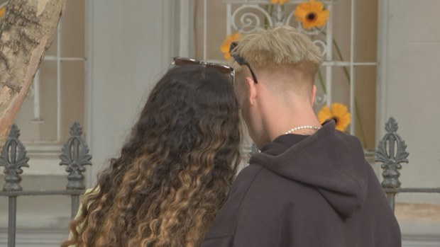 Friends gathered outside of Baird's Paddington home in mourning.