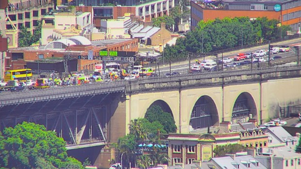 One man has died after three cars and a bus crashed on Sydney's Harbour Bridge. 