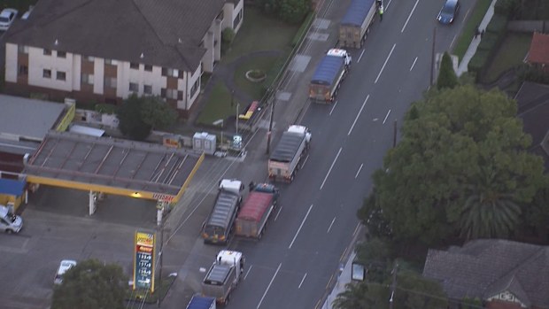 Dozens of trucks have stopped on the Sydney Harbour and Anzac Bridges this afternoon to seek assurances transport workers will be deemed essential.