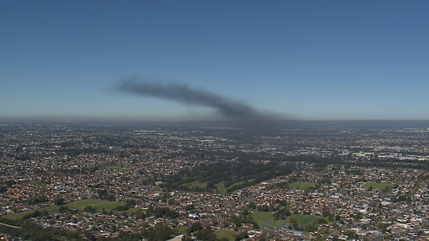 Dozens of firefighters are responding to a fifth alarm fire at a single-storey factory in Girraween.