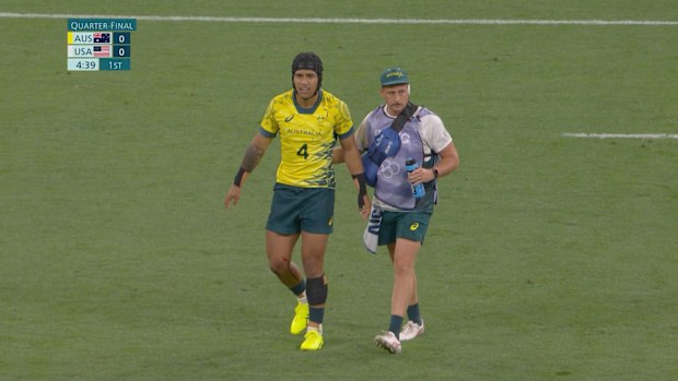 Dietrich Roache limps from the field for Australia.