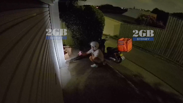 An Uber Eats driver has been caught taking a customer's food order on CCTV footage obtained by 2GB Radio. 