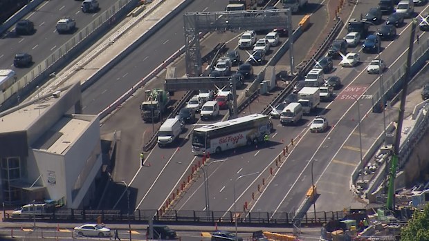 A man has died and another is fighting for life after three cars and a bus crashed on Sydney's Harbour Bridge about 1.40pm.