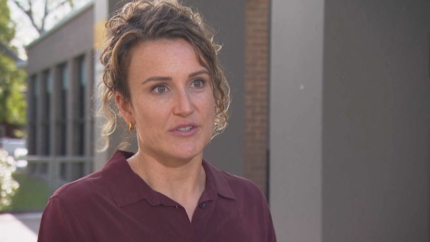 A woman who was mauled by two out of control dogs while sinking into mud on the banks of a Sydney river has told Sutherland local court she thought she was going to die.The alleged owner of the Irish wolfhounds has been charged over the attack and is accused of running away.
Footage shows Elle Booth up to her shoulders in mud clinging to her Jack Russell, under attack.