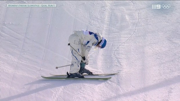 Eileen Gu returns to her feet after crashing in her opening qualification run.