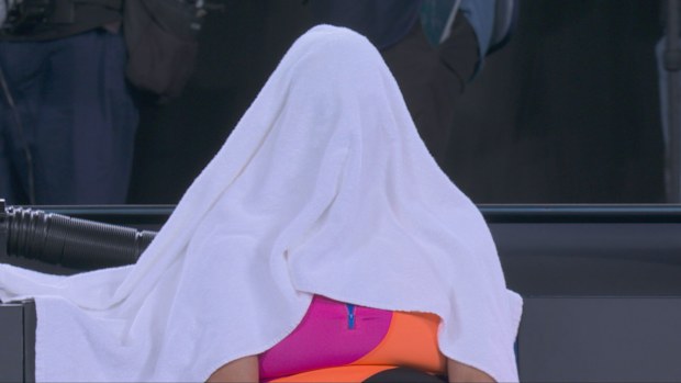 Aryna Sabalenka hides her face under a towel after losing her second-straight Australian Open final.