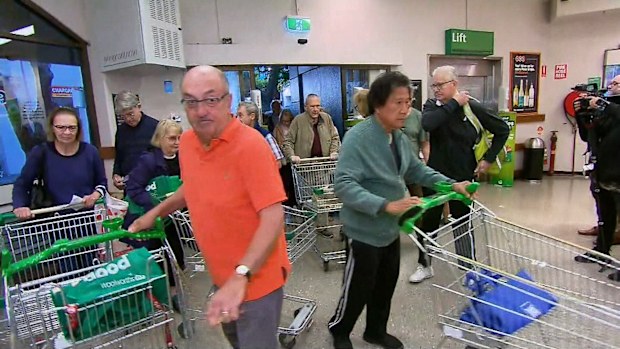 Elderly and disabled members of the community arrive at Woolworths for their dedicated shopping hour. 