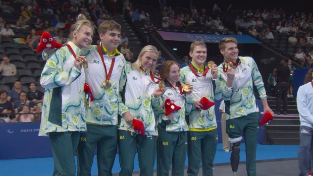 Australia's mixed 4x100m medley relay team stand atop the podium.