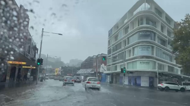 Floodwaters cover a road in Double Bay in Sydney.