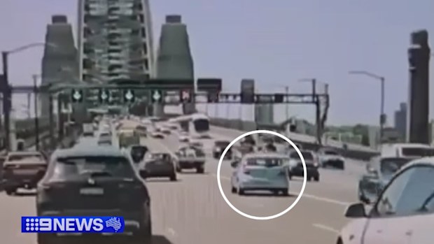 Dashcam footage shows a small hatchback veering into oncoming traffic before it collides with a car heading in the other direction. 