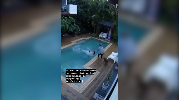 Little boy being saved from a pool.