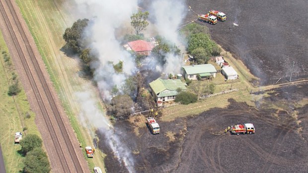 A large grassfire is burning on the edge of Sydney, with residents warned to stay updated.The fire has burned through bush around Menangle Road, near Menangle in Wollondilly, with waterbombing aircraft called in.