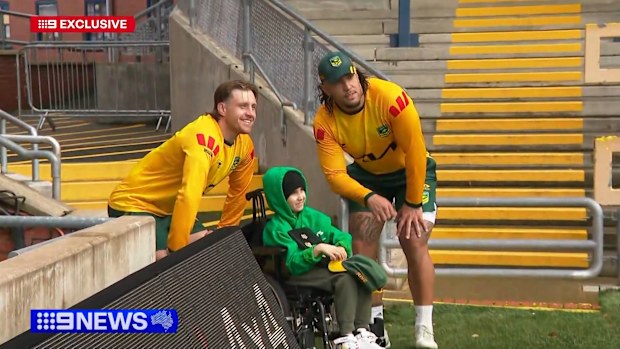 Cameron Munster (left) and Keaon Koloamatangi with Isaac, who's undergoing chemotherapy for brain cancer.
