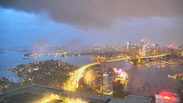 Sydney has been smashed by a wild storm which has cancelled planes and brought down trees.The storm swept through at around 7.30pm after earlier warnings.