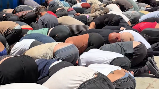Prisoners were forced to kneel with their foreheads on the floor.