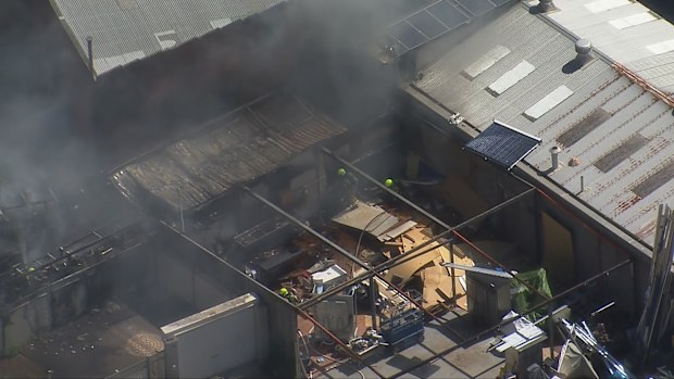 Dozens of firefighters are battling a blaze at a furniture factory in Sydney's west.