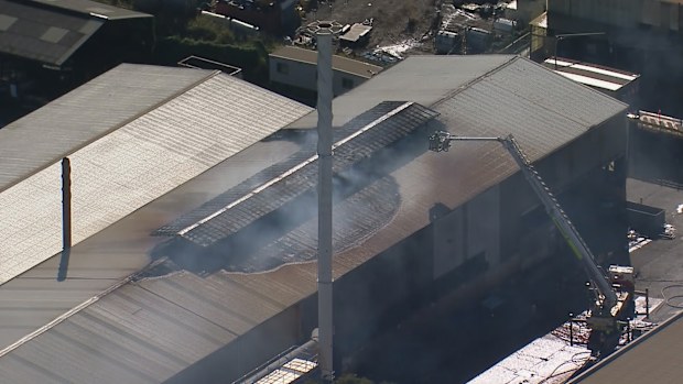 Dozens of firefighters are responding to a fifth alarm fire at a single-storey factory in Girraween.
