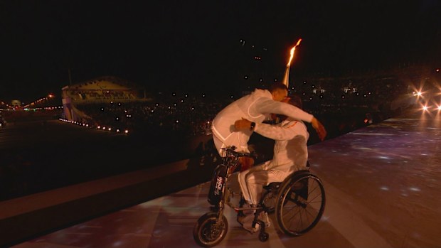 Paralympic flame enters the ceremony.