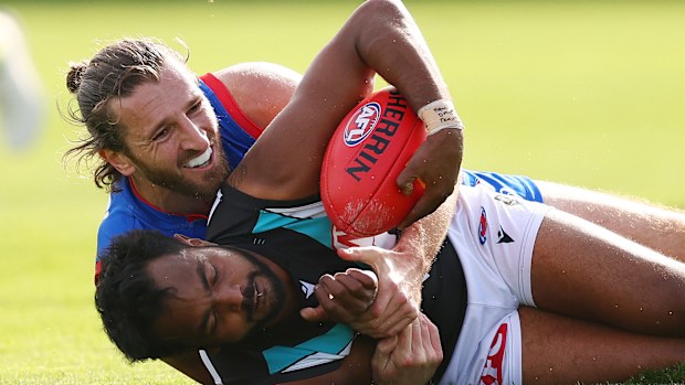 Western Bulldogs captain Marcus Bontempelli tackles Port Adelaide livewire Willie Rioli.