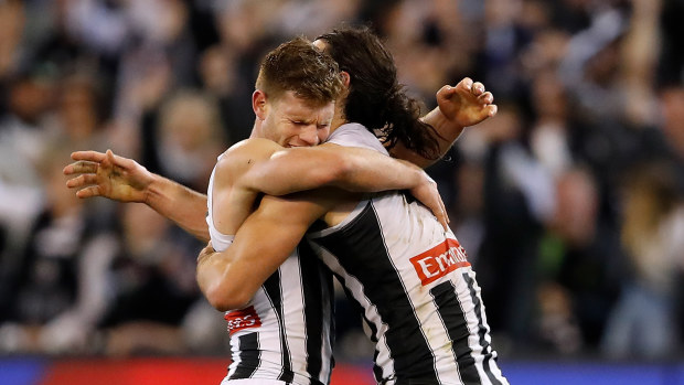Taylor Adams and Brodie Grundy celebrate on the siren during the 2018 preliminary final.