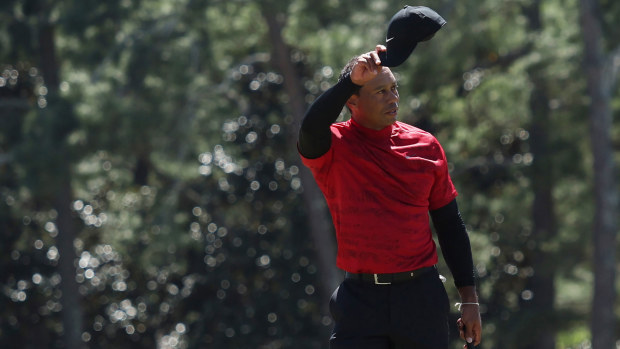 Tiger Woods acknowledges the gallery as he receives a standing ovation at the 18th hole at Augusta.