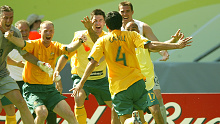 Tim Cahill is mobbed by teammates after his second goal. 