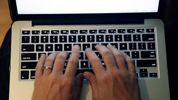 Someone typing on a laptop keyboard.