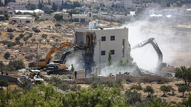 Israeli bulldozers demolish a Palestinian house in the village of Marah Ma'ala, south of Bethlehem in the occupied West Bank, July 13.