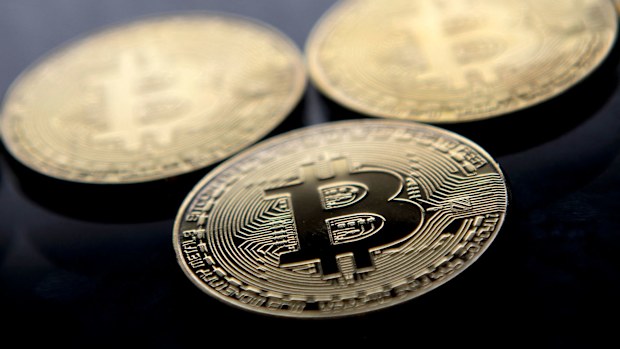 Gold-plated souvenir Bitcoin coins are arranged for a photograph in London in November 2017. Bitcoin hit a new record above $80,000 on November 10.