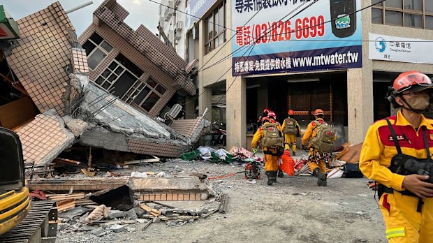 Firefighters in the search for trapped victims in a collapsed residential building following earthquake in Yuli township in Hualien County, eastern Taiwan, Sunday, Sept. 18, 2022. (Hualien County Fire Department via AP)