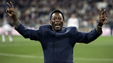 Brazil's soccer legend Pele greets the crowd ahead of a Spanish league soccer match, in the Santiago Bernabeu stadium in Madrid, Jan. 16, 2005.
