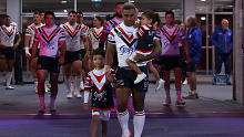 Michael Jennings walks onto the field with his children for his 300th match.