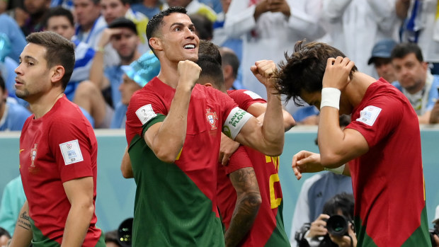 LUSAIL CITY, QATAR - NOVEMBER 28: Cristiano Ronaldo of Portugal celebrates after scoring their team's first goal with their teammates during the FIFA World Cup Qatar 2022 Group H match between Portugal and Uruguay at Lusail Stadium on November 28, 2022 in Lusail City, Qatar. (Photo by Justin Setterfield/Getty Images)