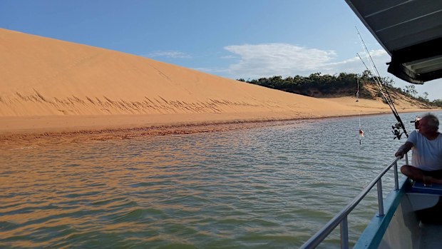 A Queensland couple were rescued by a fisherman after being stranded out at sea on paddleboards for three days.