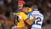 Hunter Paisami of the Wallabies is tackled by Santiago Chocobares of the Pumas.