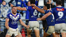 Josh Reynolds celebrates the Bulldogs' incredible golden point win with his teammates.
