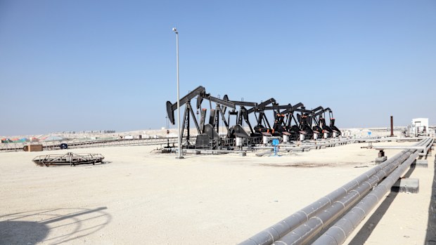 Black oil pump jacks in the desert of Bahrain.