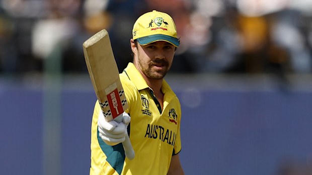 Travis Head of Australia celebrates as he raises his bat after reaching his century after scoring 100.