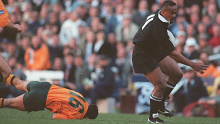 Jonah Lomu beats the tackle of David Campese to score in a 1995 Test in Sydney.