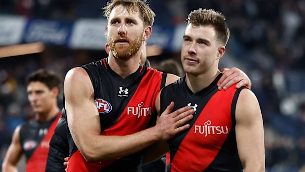 GEELONG, AUSTRALIA - JULY 15: Dyson Heppell (left) and Zach Merrett of the Bombers look dejected after a loss during the 2023 AFL Round 18 match between the Geelong Cats and the Essendon Bombers at GMHBA Stadium on July 15, 2023 in Geelong, Australia. (Photo by Michael Willson/AFL Photos via Getty Images)