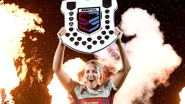 Queensland Maroon's captain Ali Brigginshaw holds up the shield as she celebrates victory after the Women's State of Origin match.