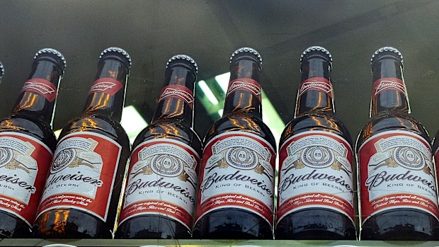 Bottles of Budweiser beer are on display in a shop window in London on Oct. 13, 2015.  
