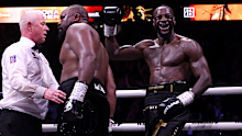 Deontay Wilder celebrates after embracing Derek Chisora.
