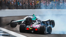 Marcus Ericsson climbs over the nose of Tom Blomqvist after the Meyer Shank Racing car spun on lap one of the 108th Indianapolis 500.