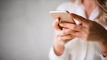 Close up of a woman using her smartphone indoors.
