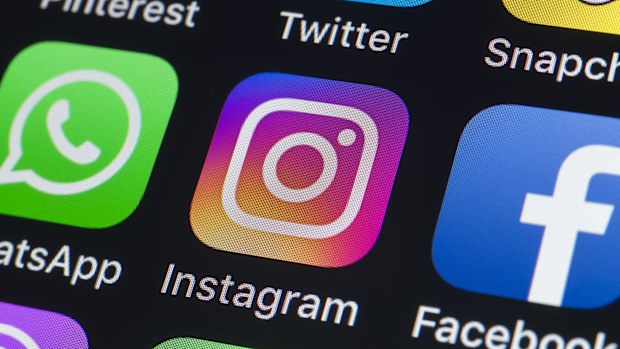 London, UK - July 24, 2018: The buttons of WhatsApp, Instagram, facebook, Twitter, Snapchat and other apps on the screen of an iPhone.
