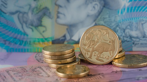 One and Two Dollar Coins Australian ten and five dollar notes in the background - Australian Currency